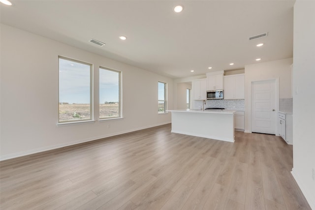 1502 Salem Dr, Forney, TX 75126 - unfurnished living room featuring light wood-style flooring and recessed lighting