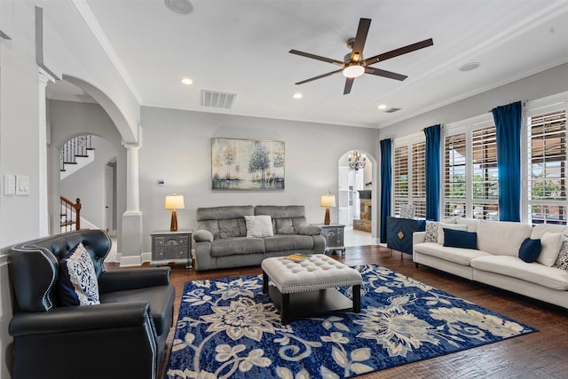 2305 Castle Creek Dr, Mansfield, TX 76063 - living area featuring arched walkways, decorative columns, a ceiling fan, crown molding, and stairway