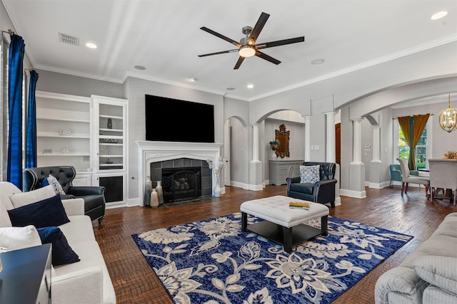2305 Castle Creek Dr, Mansfield, TX 76063 - living area featuring arched walkways, a ceiling fan, wood finished floors, ornamental molding, and decorative columns