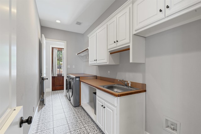2305 Castle Creek Dr, Mansfield, TX 76063 - kitchen featuring white cabinetry, washing machine and clothes dryer, light tile patterned flooring, and recessed lighting