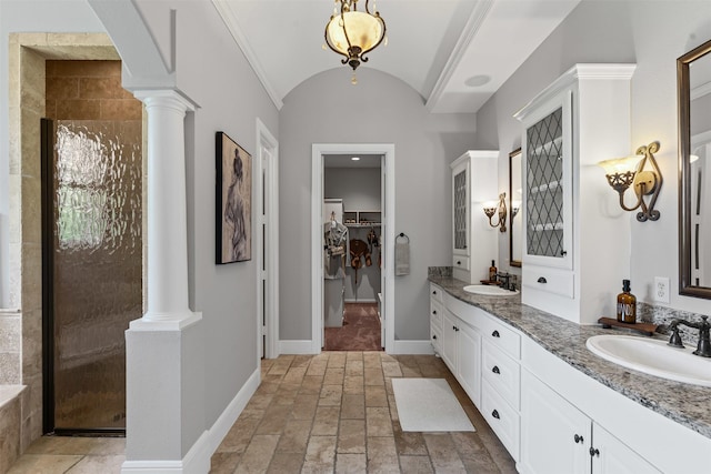 2305 Castle Creek Dr, Mansfield, TX 76063 - bathroom with ornate columns, double vanity, stone tile flooring, a shower stall, and a walk in closet