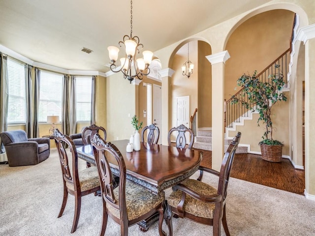 1721 Cross Point Rd, Mckinney, TX 75070 - carpeted dining area featuring a chandelier, stairs, arched walkways, and ornate columns