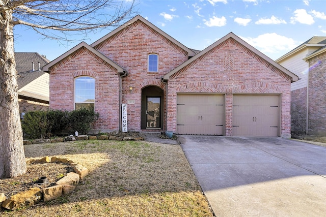 5201 Datewood Ln, Mckinney, TX 75071 - french country inspired facade featuring brick siding, a garage, and driveway