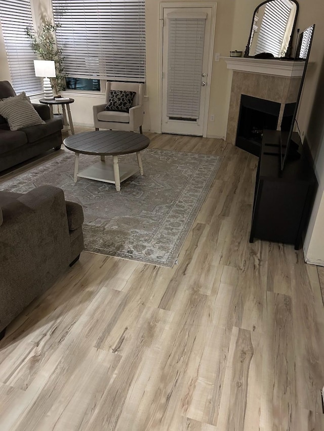 5201 Datewood Ln, Mckinney, TX 75071 - living room featuring a tiled fireplace and wood finished floors