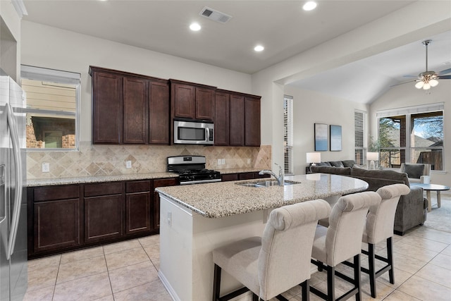 5201 Datewood Ln, Mckinney, TX 75071 - kitchen with stainless steel appliances, open floor plan, light tile patterned floors, tasteful backsplash, and recessed lighting