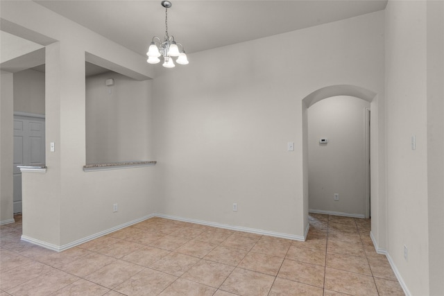 5201 Datewood Ln, Mckinney, TX 75071 - spare room with arched walkways, a chandelier, and light tile patterned flooring