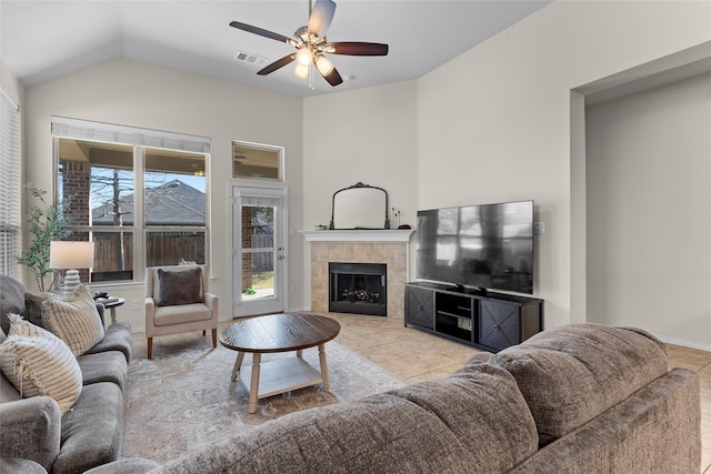 5201 Datewood Ln, Mckinney, TX 75071 - living room with a ceiling fan, a tiled fireplace, and vaulted ceiling