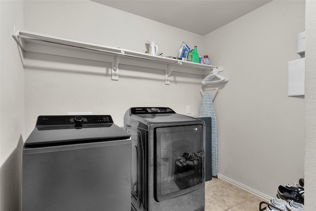 5201 Datewood Ln, Mckinney, TX 75071 - laundry area featuring washing machine and clothes dryer and light tile patterned floors