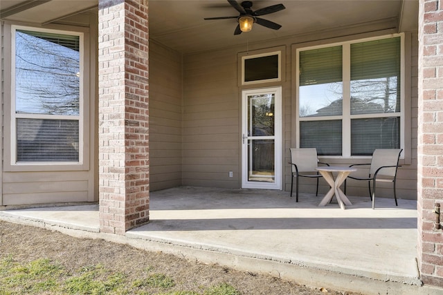 5201 Datewood Ln, Mckinney, TX 75071 - view of exterior entry featuring brick siding, ceiling fan, and a patio area