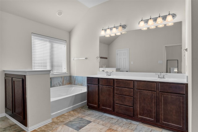 5201 Datewood Ln, Mckinney, TX 75071 - bathroom with lofted ceiling, a bath, and double vanity