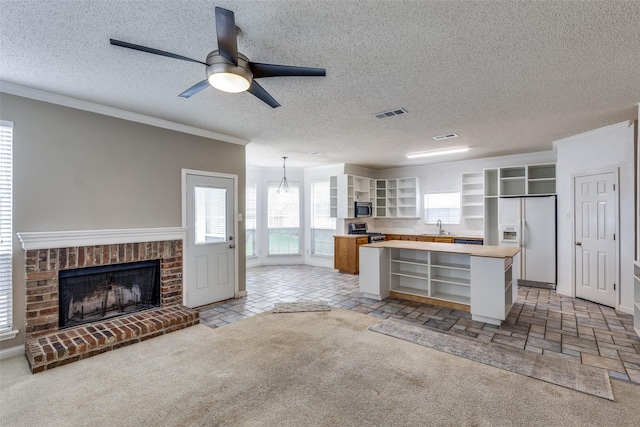 7504 Lomo Alto, Plano, TX 75024 - kitchen featuring open shelves, stainless steel appliances, wood counters, a fireplace, and a center island