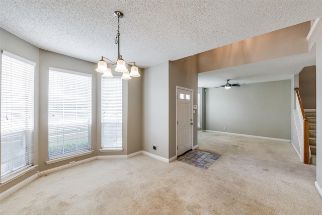 7504 Lomo Alto, Plano, TX 75024 - unfurnished dining area with carpet floors, a chandelier, healthy amount of natural light, a textured ceiling, and stairs