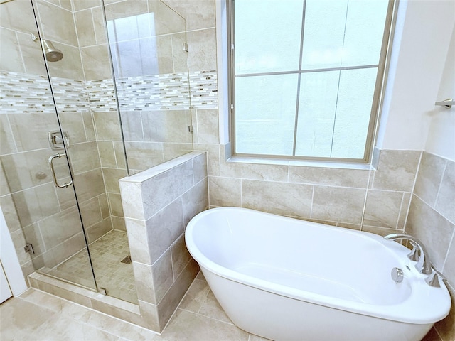 5339 Holland Ave, Dallas, TX 75209 - full bathroom featuring a freestanding tub, a shower stall, tile walls, and tile patterned floors