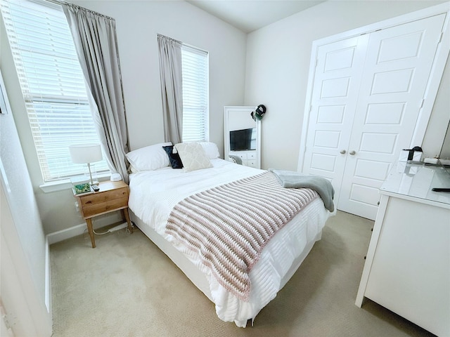 5339 Holland Ave, Dallas, TX 75209 - bedroom with light colored carpet, multiple windows, and a closet