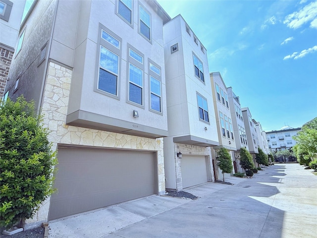 5339 Holland Ave, Dallas, TX 75209 - view of property with an attached garage, a residential view, and concrete driveway