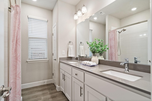 3680 Twin Pines Dr, Grand Prairie, TX 76065 - bathroom featuring wood finished floors, double vanity, a shower with shower curtain, and recessed lighting