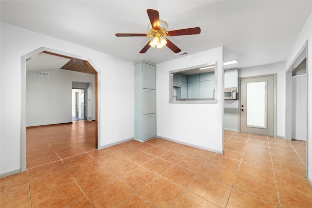10900 Fm 1189, Lipan, TX 76462 - empty room featuring a ceiling fan, light tile patterned floors, and arched walkways