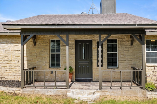 10900 Fm 1189, Lipan, TX 76462 - doorway to property featuring stone siding, a shingled roof, and covered porch