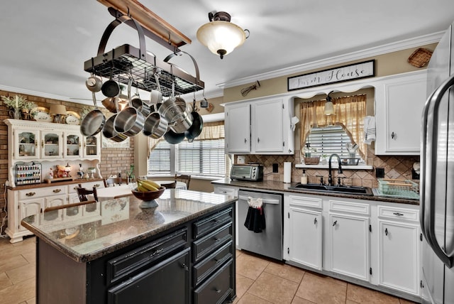 112 Rolling Meadow Ln, Bossier City, LA 71112 - kitchen with appliances with stainless steel finishes, white cabinets, backsplash, and ornamental molding