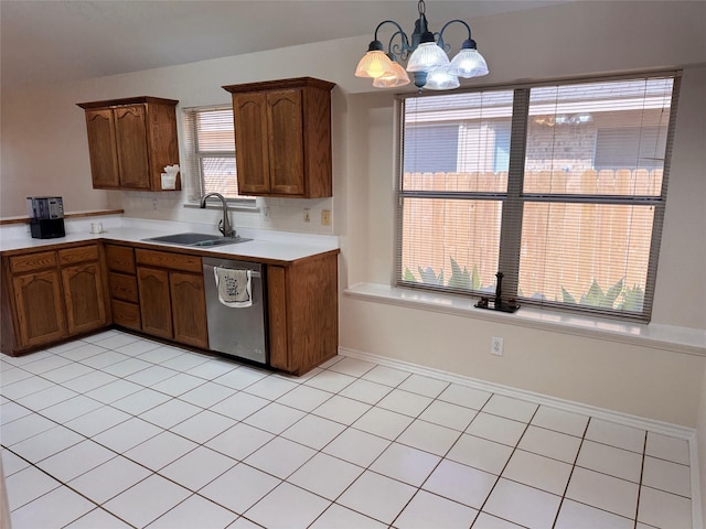 5216 Tartan Cir, Denton, TX 76208 - kitchen featuring dishwasher, a chandelier, light countertops, hanging light fixtures, and light tile patterned floors