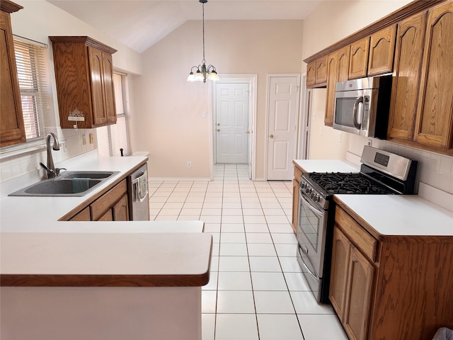 5216 Tartan Cir, Denton, TX 76208 - kitchen featuring appliances with stainless steel finishes, backsplash, a chandelier, vaulted ceiling, and hanging light fixtures