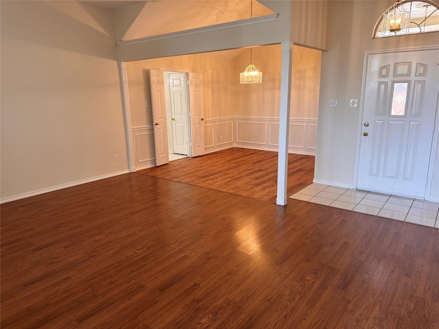 5216 Tartan Cir, Denton, TX 76208 - foyer entrance featuring a chandelier, wood finished floors, a towering ceiling, and a decorative wall