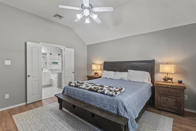 1732 Jasmine Trl, Savannah, TX 76227 - bedroom featuring lofted ceiling, wood finished floors, connected bathroom, and ceiling fan