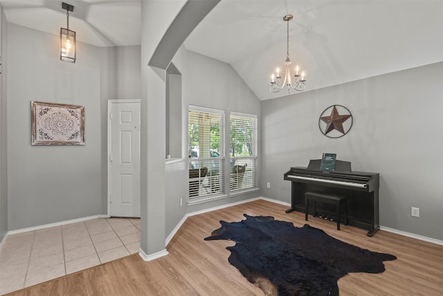 1732 Jasmine Trl, Savannah, TX 76227 - entryway featuring vaulted ceiling, a chandelier, wood finished floors, and arched walkways