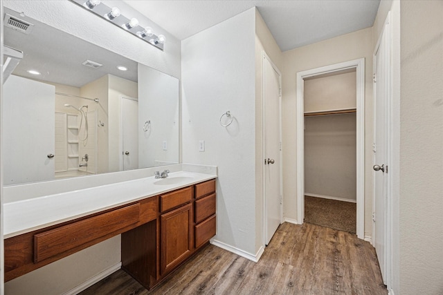 330 Broken Bow, Krum, TX 76249 - bathroom featuring vanity, wood finished floors, and a spacious closet