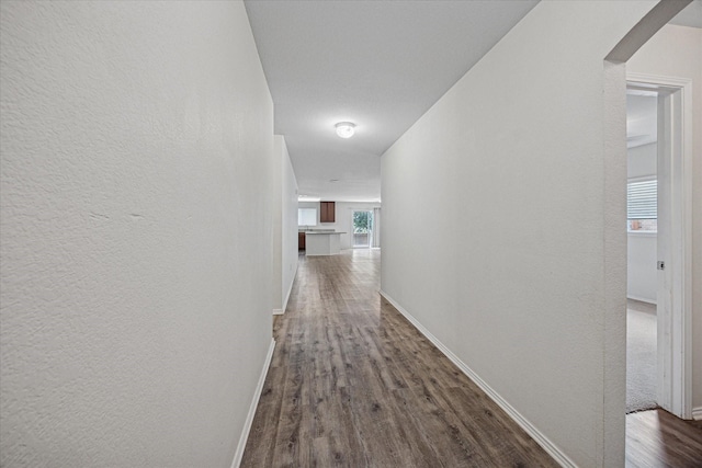 330 Broken Bow, Krum, TX 76249 - corridor featuring dark wood-style floors, arched walkways, and a textured wall