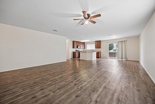 330 Broken Bow, Krum, TX 76249 - unfurnished living room featuring dark wood-style flooring and a ceiling fan