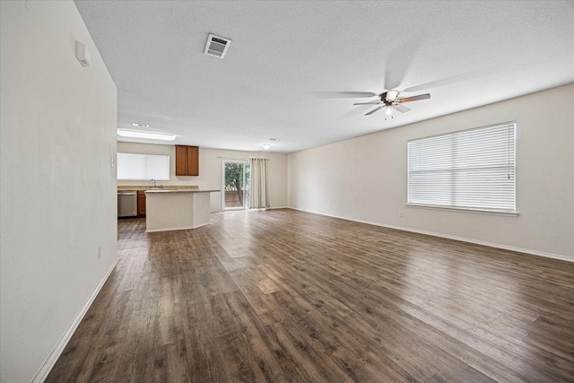 330 Broken Bow, Krum, TX 76249 - unfurnished living room with dark wood-type flooring and ceiling fan