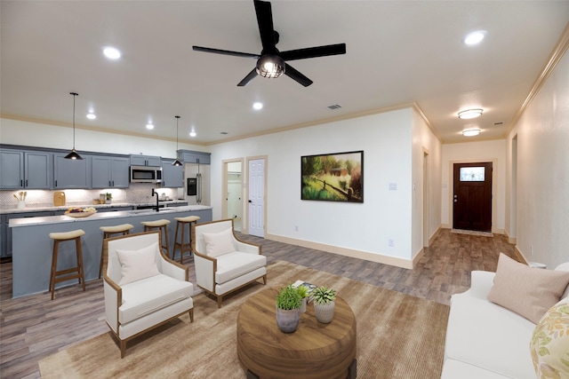 2621 Canton Dr, Fort Worth, TX 76112 - living area featuring light wood-style floors, ornamental molding, recessed lighting, and ceiling fan