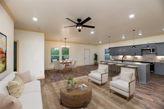 2621 Canton Dr, Fort Worth, TX 76112 - living room with wood finished floors, ornamental molding, recessed lighting, ceiling fan, and a chandelier