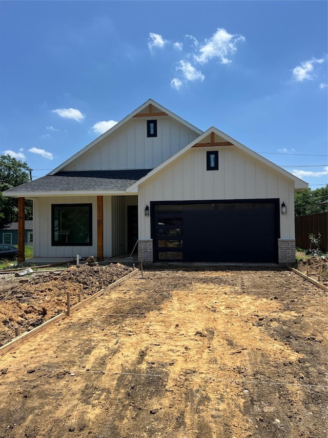 1117 Fort Worth, Grand Prairie, TX 75050 - modern farmhouse with driveway, an attached garage, brick siding, and a shingled roof