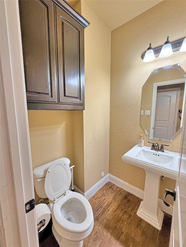 14249 Fall Harvest Dr, Frisco, TX 75033 - half bath with wood finished floors and a textured wall