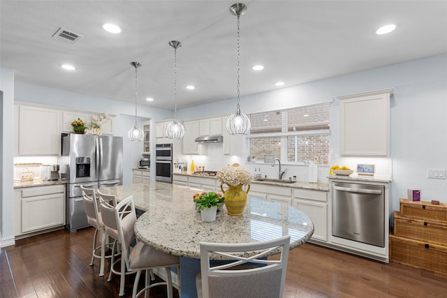 2142 Flagship Ct, Frisco, TX 75036 - kitchen with appliances with stainless steel finishes, white cabinetry, dark wood finished floors, and recessed lighting