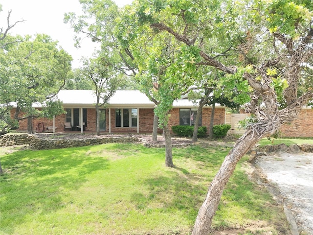 18 Tula Ct, Nocona, TX 76255 - view of front facade with a front lawn, brick siding, and a porch