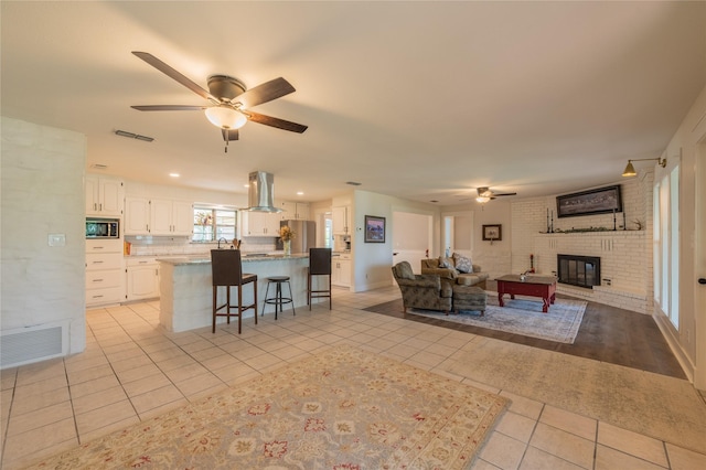 18 Tula Ct, Nocona, TX 76255 - living area featuring ceiling fan, light tile patterned floors, and a fireplace