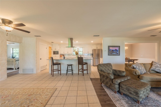 18 Tula Ct, Nocona, TX 76255 - living room with ceiling fan, light tile patterned floors, plenty of natural light, and recessed lighting