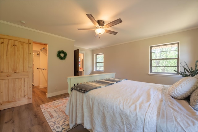 18 Tula Ct, Nocona, TX 76255 - bedroom featuring wood finished floors, crown molding, a spacious closet, and a ceiling fan
