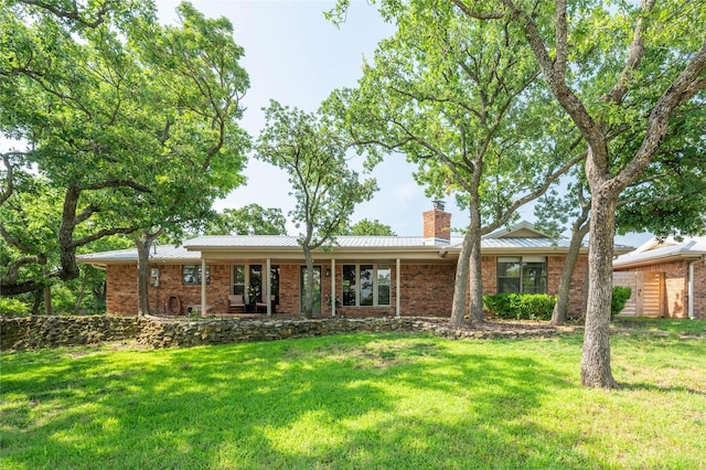 18 Tula Ct, Nocona, TX 76255 - ranch-style house with a chimney, a front yard, and brick siding