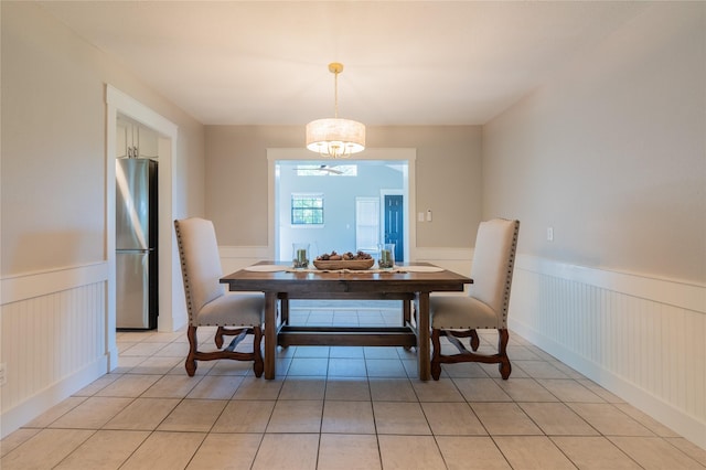 18 Tula Ct, Nocona, TX 76255 - dining area featuring a wainscoted wall, light tile patterned floors, and a decorative wall