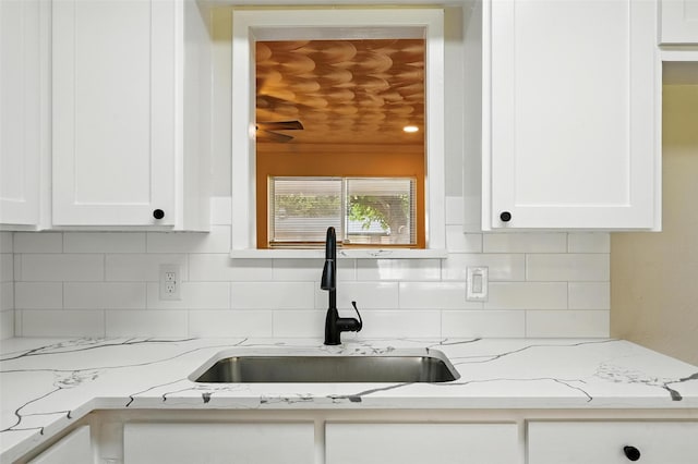 324 Jasmine Ct, Burleson, TX 76028 - kitchen featuring white cabinetry, backsplash, and light stone countertops