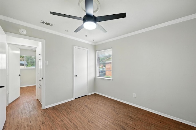 324 Jasmine Ct, Burleson, TX 76028 - unfurnished bedroom featuring multiple windows, wood finished floors, crown molding, ceiling fan, and a closet