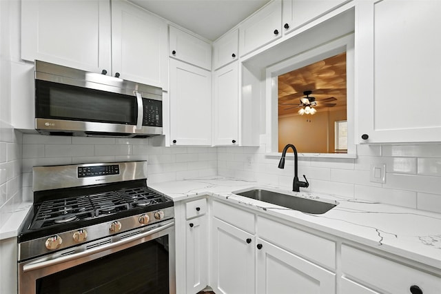 324 Jasmine Ct, Burleson, TX 76028 - kitchen featuring stainless steel appliances, white cabinets, decorative backsplash, and light stone countertops