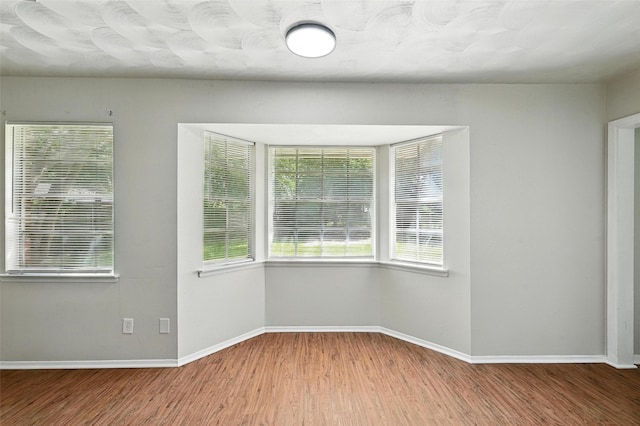 324 Jasmine Ct, Burleson, TX 76028 - empty room with wood finished floors and baseboards