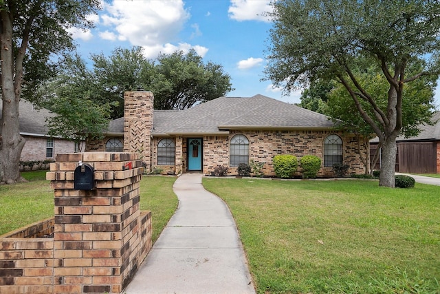 1112 Indian Ridge Dr, Denton, TX 76205 - view of front of property featuring roof with shingles, a chimney, a front lawn, and brick siding