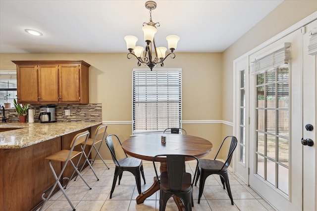 1112 Indian Ridge Dr, Denton, TX 76205 - dining area with plenty of natural light, a chandelier, and light tile patterned floors