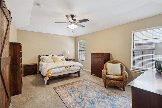 1112 Indian Ridge Dr, Denton, TX 76205 - bedroom with light carpet, a barn door, and ceiling fan